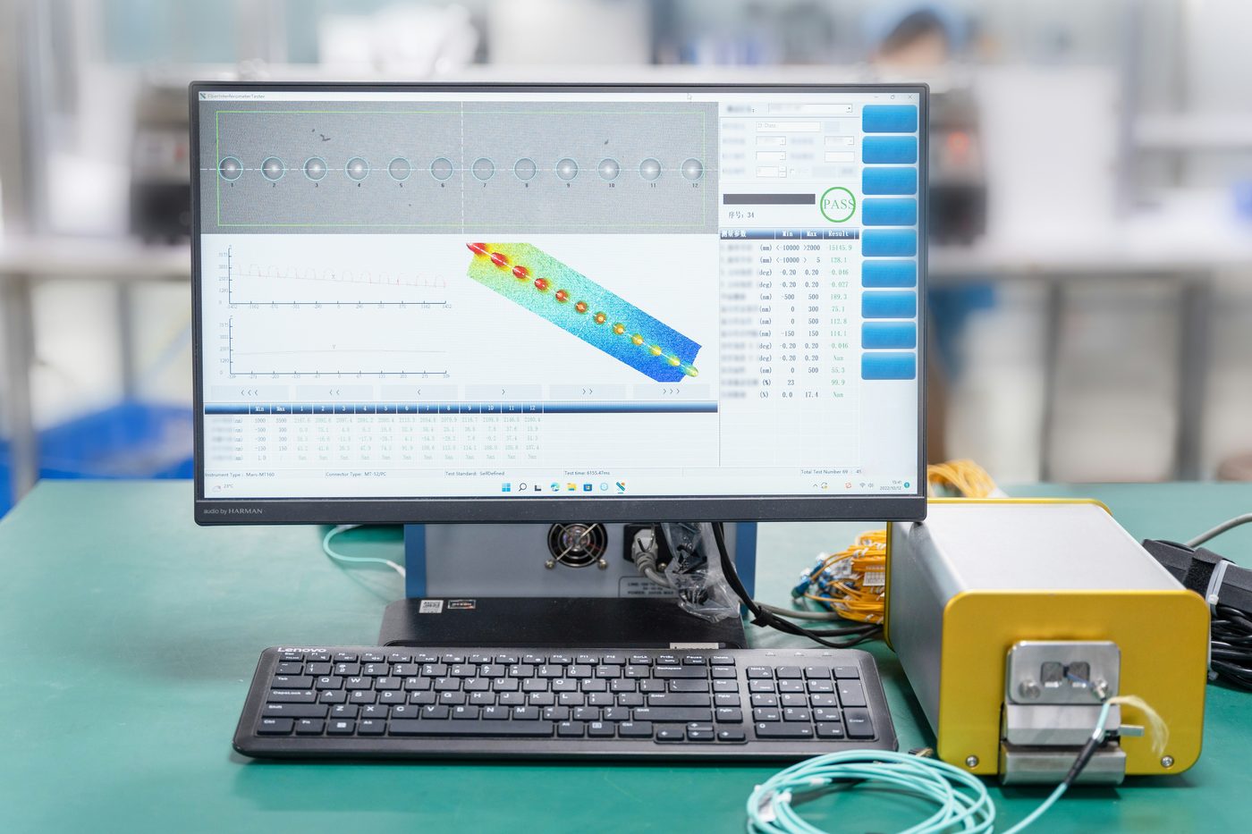 Fiber optic test bench with measurement readouts and a PASS quality control result